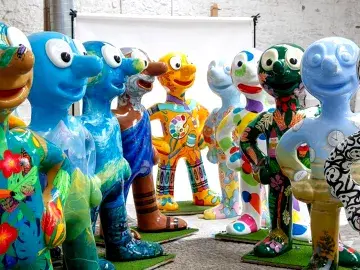 A row of decorated morph sculptures stood together