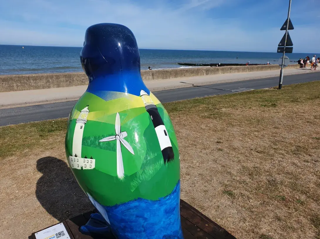 Decorated puffin sculpture overlooking the beach