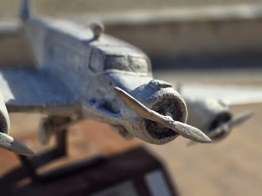 Close up view of a metal aircraft sculpture from the front engine